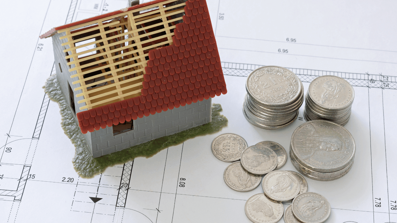 Model house and coins representing financial wellness, side income, and building a better future through intentional decisions.